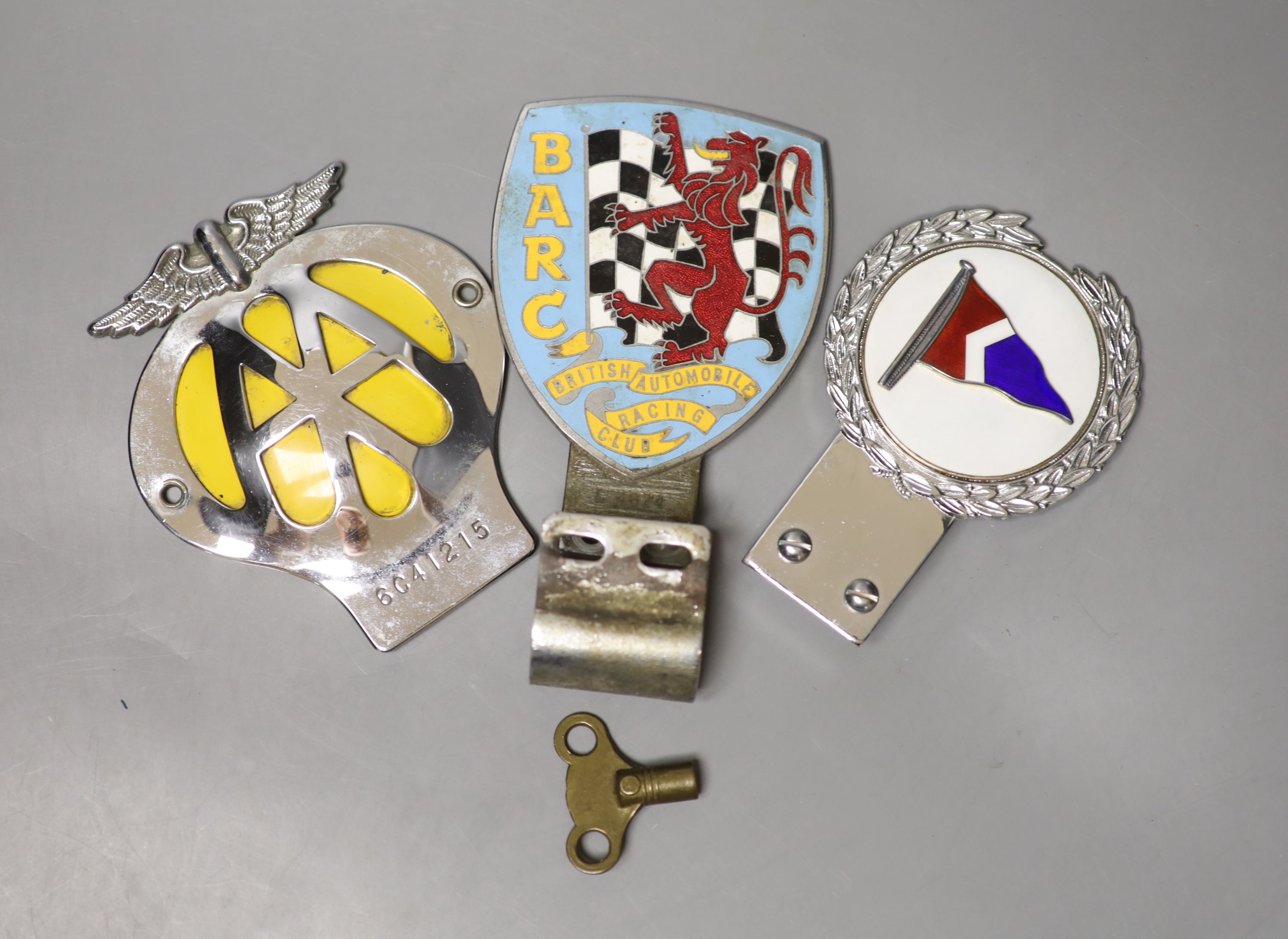 A British Automobile Racing Club car badge, an AA badge and one other